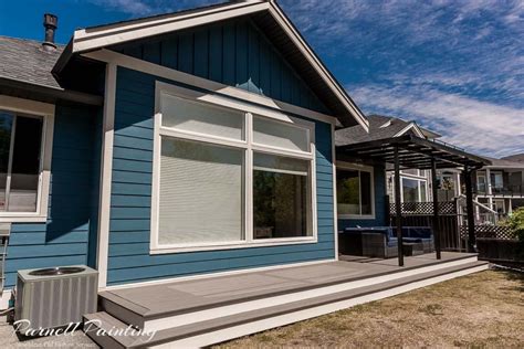 Blue Exterior Siding With Cream Coloured Trim Work