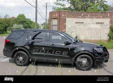 Detroit Police Department Gang Enforcement vehicle by a wall covered in ...