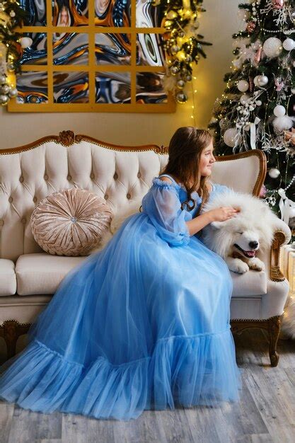Premium Photo | Nice girl in a light blue dress with white samoyed dog