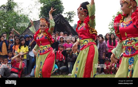 The three young girls dancing on a traditional folk culture ceremony in West Java, Indonesia ...