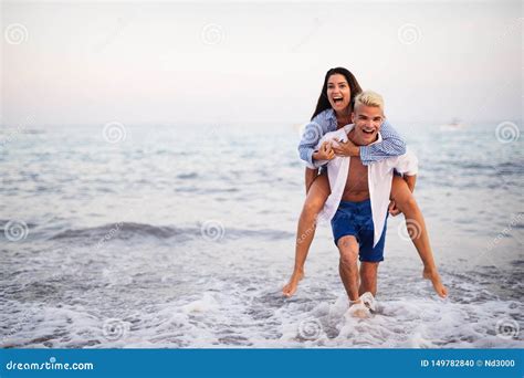 Happy Young Couple Having Fun and Love on the Beach Stock Photo - Image of holiday, happiness ...