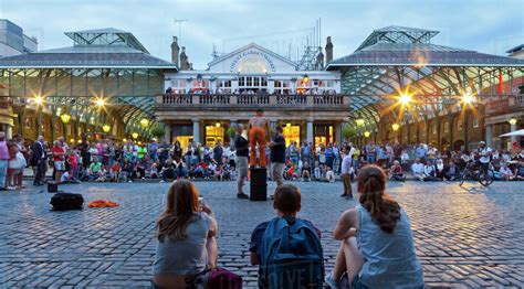 Crowd watching street performers at Covent Garden, London, England, United Kingdom, Europe ...