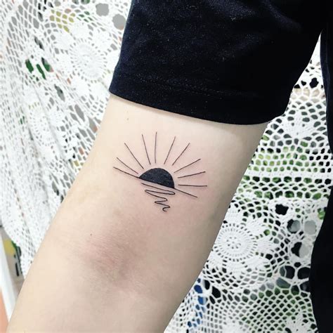 Minimalist black sunrise tattoo on the right arm | Sun tattoo designs ...