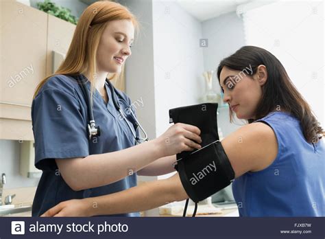 Putting on blood pressure cuff hi-res stock photography and images - Alamy