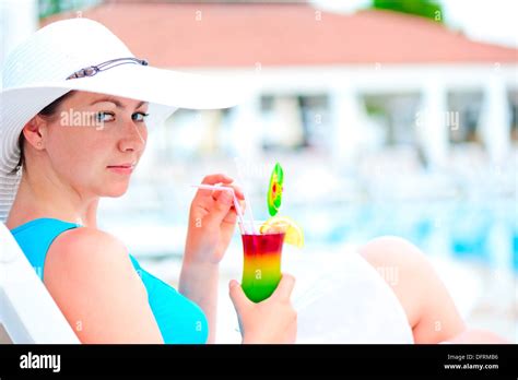 girl is resting on a sun lounger with a cocktail Stock Photo - Alamy