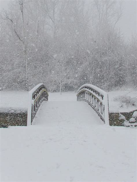 Walking bridge over a small creek in a heavy snow storm-Howard C ...