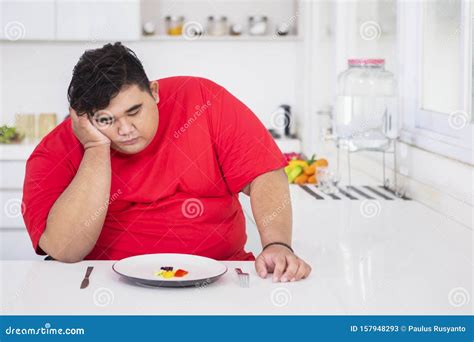 Young Fat Man Looks Bored To Eat Salad Stock Image - Image of dieting, dilemma: 157948293