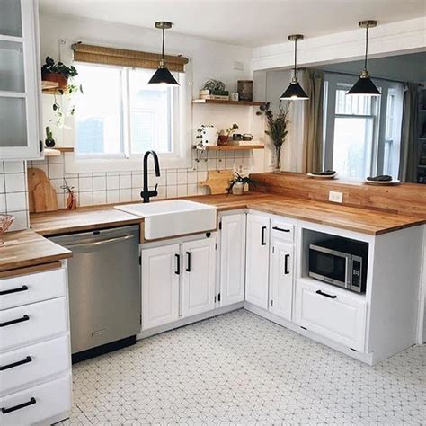 farmhouse kitchen with butcher block countertops white cabinets and pattern flooring #kitcheni ...