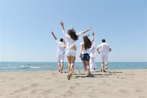 happy people group have fun and running on beach 12642958 Stock Photo at Vecteezy