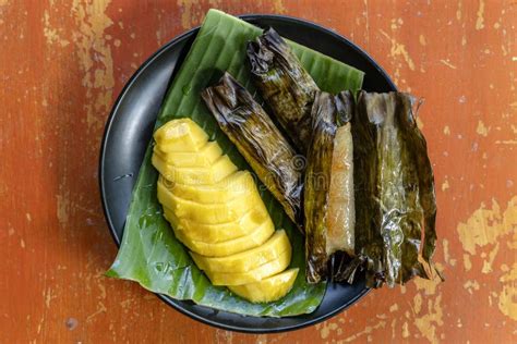 Thai Style Dessert, Yellow Mango with Banana Sticky Rice in Palm Leaves. Yellow Mango and Sticky ...