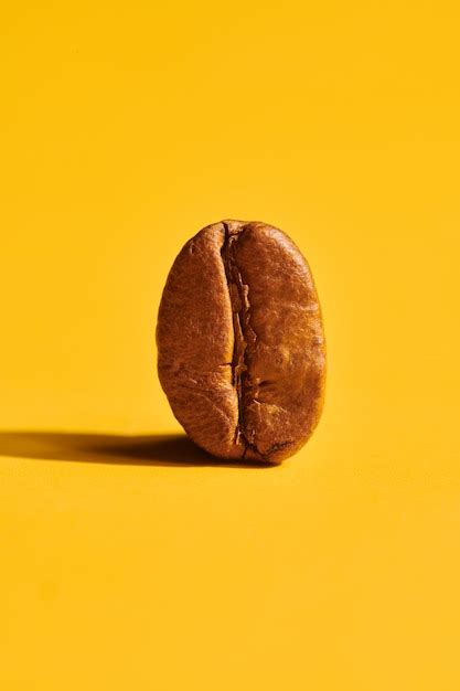 Premium Photo | Roasted coffee beans on yellow background