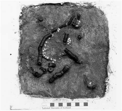 Early Bronze Age cannel coal and lead necklace, as excavated ...