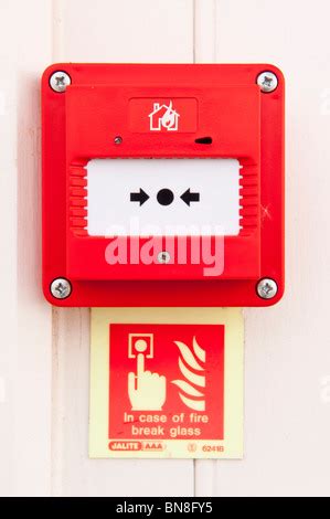 Fire break glass here button alarm red box on wall Stock Photo - Alamy