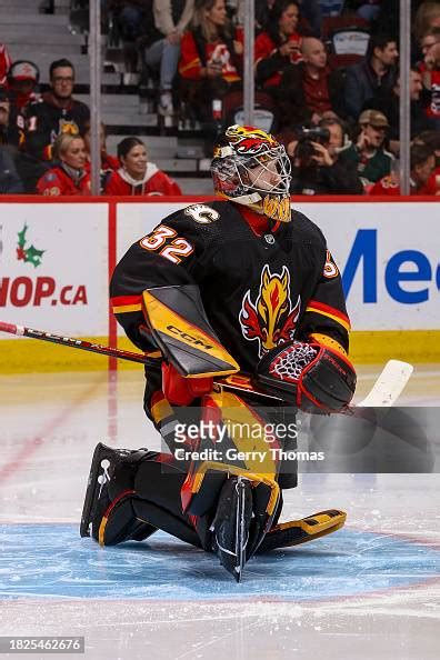 Dustin Wolf of the Calgary Flames stretches in net against the... News ...