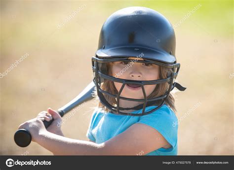 Kid baseball ready to bat. Child batter about to hit a pitch during a ...