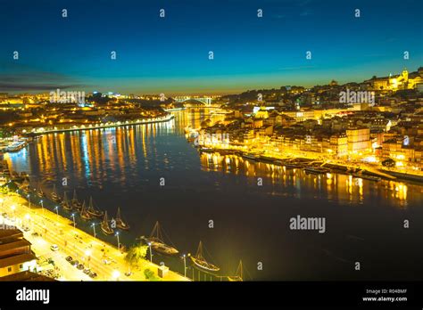 Rabelo and tourist boats on Douro River. Porto nightlife of Oporto skyline and Ribeira ...