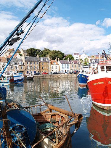 there are many boats that are docked in the water near each other and some buildings