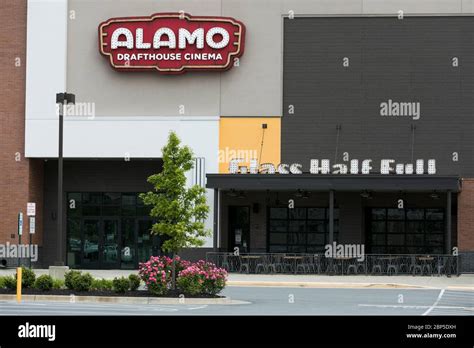 A logo sign outside of a The Alamo Drafthouse Cinema movie theater location in Charlottesville ...