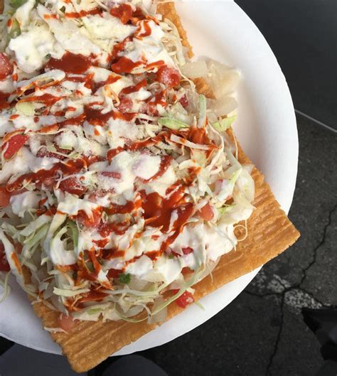 a white plate topped with pizza covered in toppings