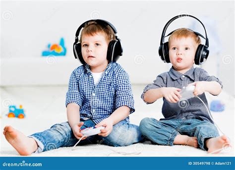 Two Brothers Playing on a Games Console Stock Photo - Image of attractive, cute: 30549798