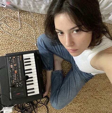 a woman laying on the floor next to an electronic keyboard