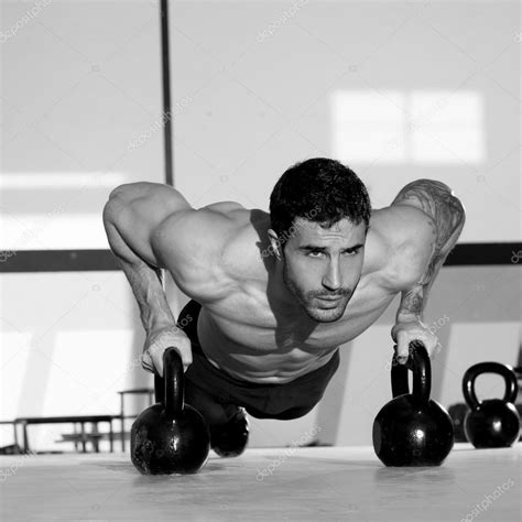 Gym man push-up strength pushup with Kettlebell Stock Photo by ©lunamarina 18027229