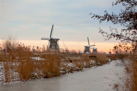 Windmills in Kinderdijk at Winter Sunset Stock Photo - Image of river, frozen: 18640818