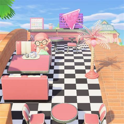 a restaurant with checkered flooring and pink tables, chairs, and palm trees