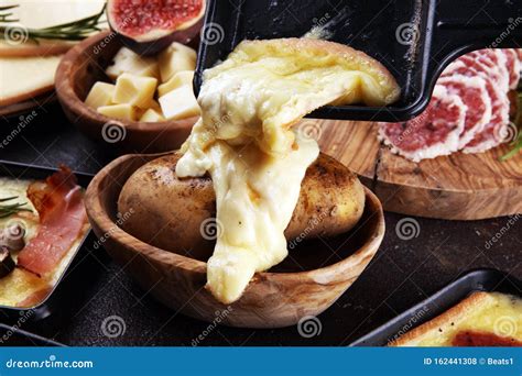 Delicious Traditional Swiss Melted Raclette Cheese on Diced Boiled or ...