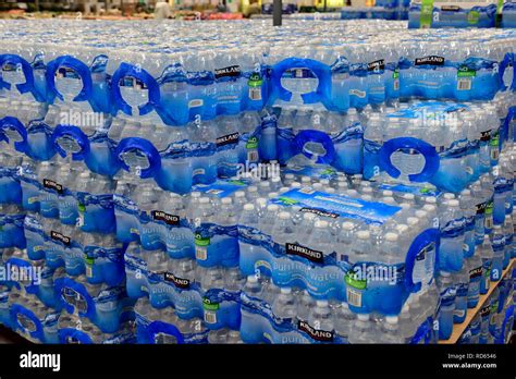 Large stacks of bottles of water in plastic bottles for sale in Costco wholesale Stock Photo - Alamy