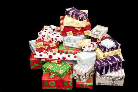 Photo of Pile of colorful Christmas gifts on black | Free christmas images