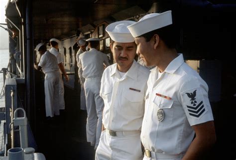 Crew members discuss watch activities aboard the ammunition ship USS ...