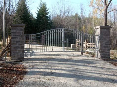 Driveway gate on stone pillars | Stone pillars, Pillars, Driveway entrance