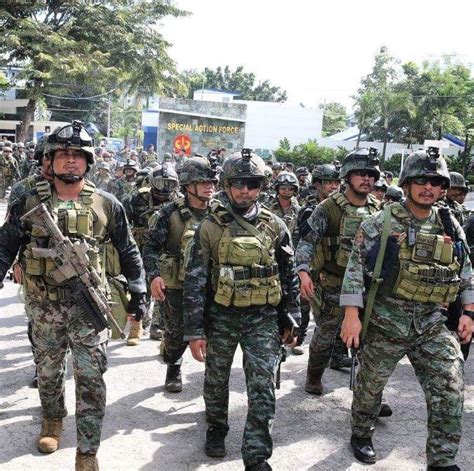 Police commandos from the Special Action Force (PNP-SAF) marching victoriously back to their ...