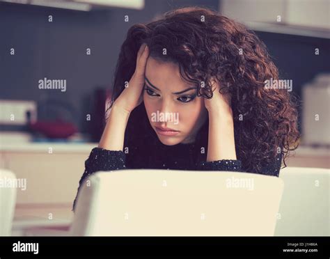 Portrait of stressed sad young housewife sitting in modern kitchen Stock Photo - Alamy