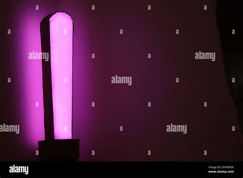 Modern desk lamp with purple light. Mood lamp with colors controlled by a phone Stock Photo - Alamy
