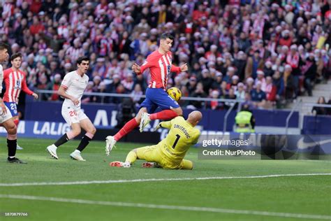 Alvaro Morata of Atletico de Madrid and Marko Dmitrovic of Sevilla ...