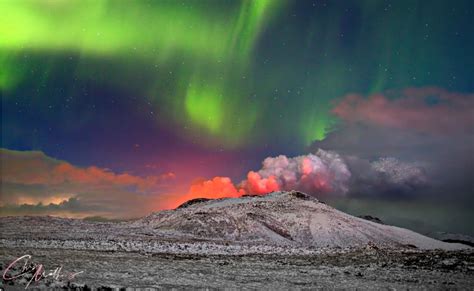 Photographer captures northern lights dancing over erupting volcano in ...