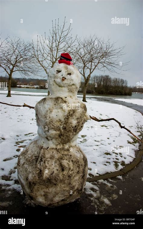 Dirty Snowman with writing visible in dirt Stock Photo - Alamy