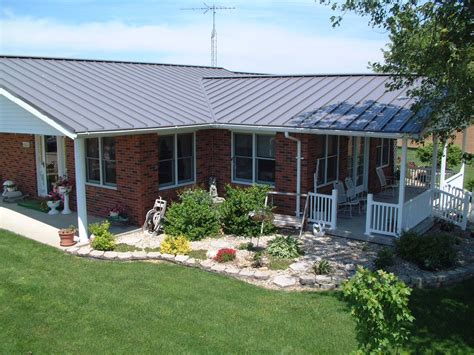 Grey painted metal roof with red brick | Red brick house, Metal roof ...