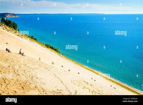 Sleeping Bear Dunes, August 8, 2016: People climbing steep sand dune in ...