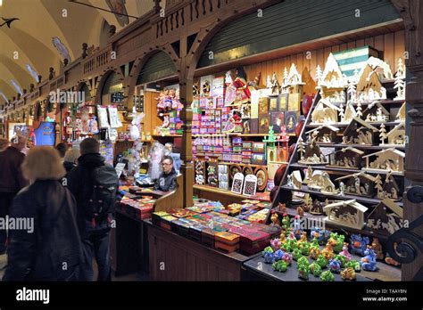 KRAKOW, POLAND - MAY 12, 2014: Vendor sells Polish traditional handicraft souvenirs in Cloth ...