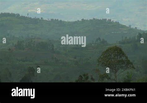 Slow zoom out reveals the Virunga volcano chain on the Rwanda Congo ...