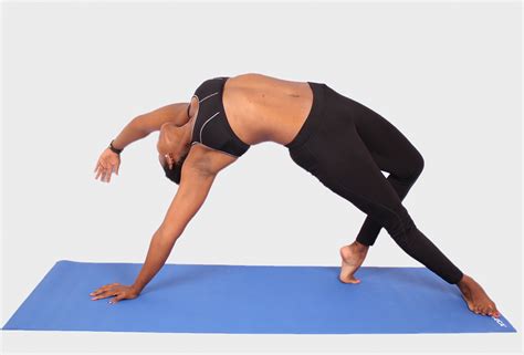 Woman doing yoga pose on blue yoga mat