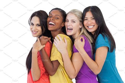 Diverse young women laughing at camera and embracing | Stock Photos ~ Creative Market