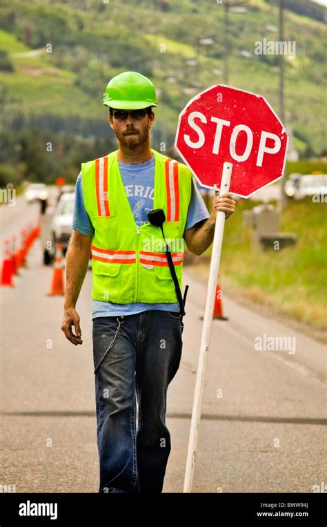 road worker holding stop sign Stock Photo - Alamy