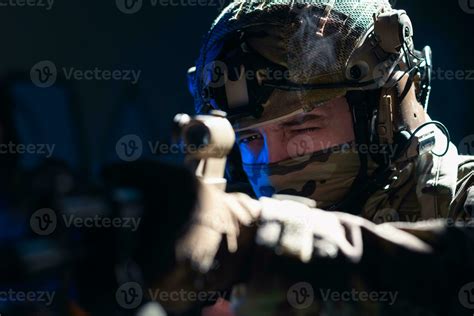 Army soldier in Combat Uniforms with an assault rifle and combat helmet ...