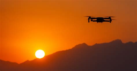 Silhouette of Flying Drone at Sunset · Free Stock Photo