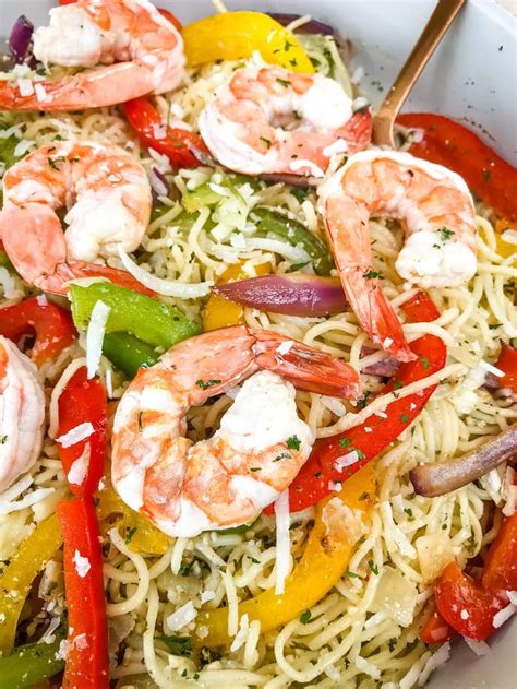 Copycat Olive Garden Shrimp Scampi recipe is made with colored bell peppers, red onion, and ...
