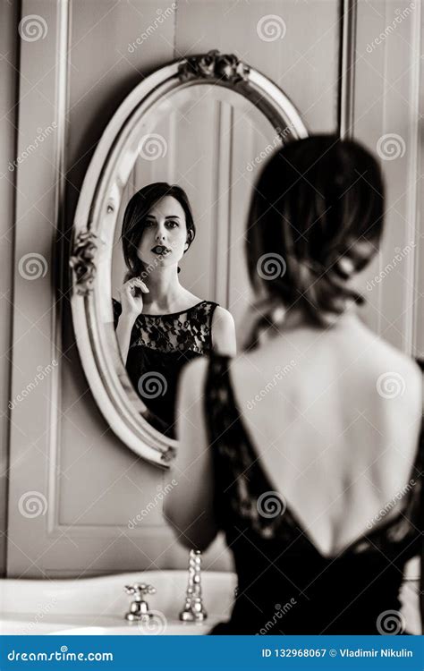 Young Woman Looking in Mirror Stock Image - Image of skinny, beauty: 132968067